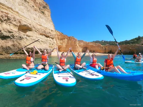 Guide fitting a life vest before the Benagil Cave paddleboard tour